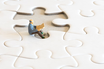 White puzzle with reading old man - miniature art