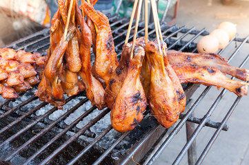 Grilled chicken leg and  wings on grill, in Thailand