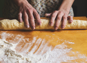 Woman kneading dough on a table