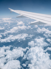 Fototapeta na wymiar Fun Clouds under Airplane Wing