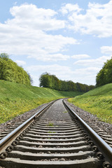 Fototapeta premium Railroad track curve around a bend in rural 