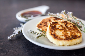 Cottage cheese pancakes with sour cream and strawberry sauce