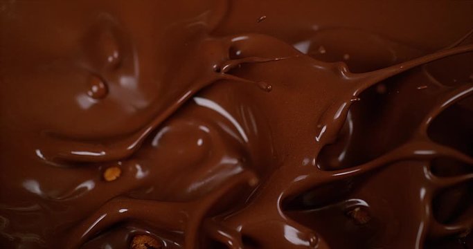 Hazelnuts Falling in Milk Chocolate, Slow Motion 4K