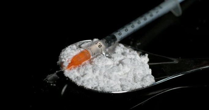 Drug, Cocaine in spoon against black background, Slow motion 4K