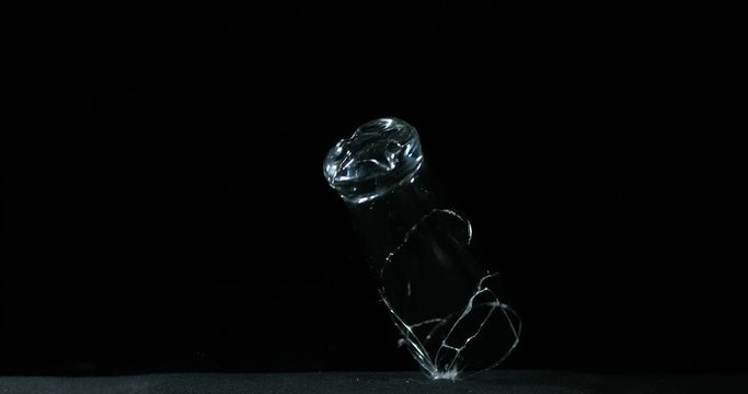 Glass Falling and exploding on Black Background, Slow Motion 4K