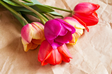 Colorful fresh flowers in bouquet on wrapping paper