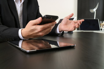 businessman working with smart phone and digital tablet and laptop computer in modern office