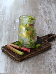 refreshing drink with ice on a wooden background. 