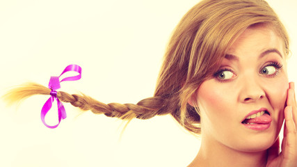 Teenage girl in braid hair making funny face