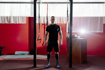 Muscular bearded man preparing for training his biceps and back in gym with pull ups. Workout lifestyle concept