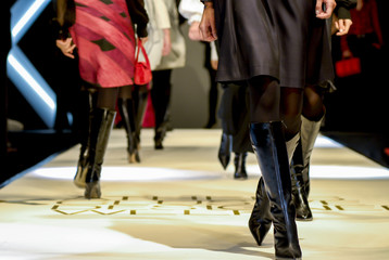 models are walking - female legs on a fashion show - obrazy, fototapety, plakaty