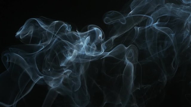 Smoke of Cigarette rising against Black Background, Slow Motion