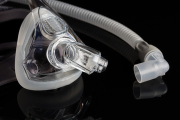 Sleep apnea CPAP mask on the black background