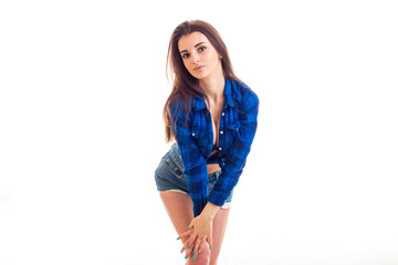 a charming young brunette in a blue shirt in the box bent forward and keeps hands on knees