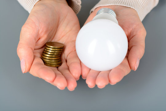 Woman keep your coins and led light bulb