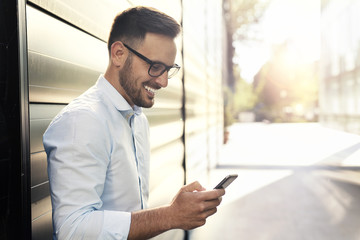 Young handsome man using smart phone