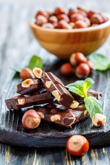 Dark chocolate with hazelnuts and mint leaves.