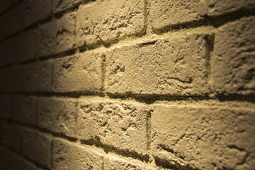 Lamp lights the brick wall with white brick