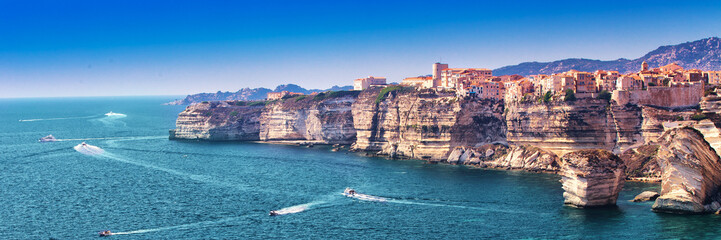 Bonifacio town on beautiful white rock cliff with sea bay, Corsica, France, Europe. - obrazy, fototapety, plakaty