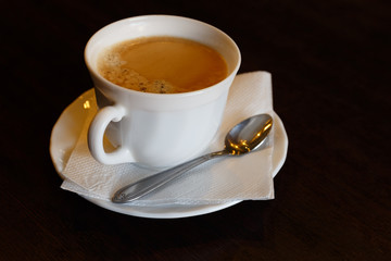 Cup of hot coffee as business breakfast on a dark background
