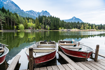 Boats on the Alpine Lake in Dolomites mountains, Sudtirol, Italy. South Tyrol.