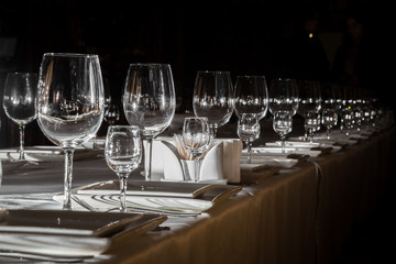 catering table set service with silverware, napkin and glass at restaurant before party