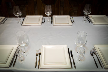 catering table set service with silverware, napkin and glass at restaurant before party