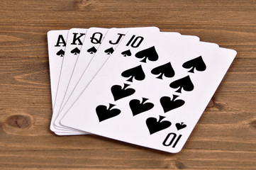 combination of royal flush of playing cards on a wooden background