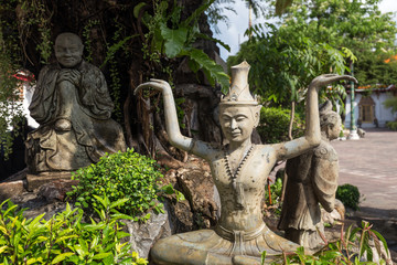 Fototapeta na wymiar Three statues at the Wat Pho (Po) temple complex in Bangkok, Thailand.