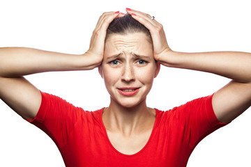 Portrait of sad unhappy woman in red t-shirt with freckles. studio shot. isolated on white...