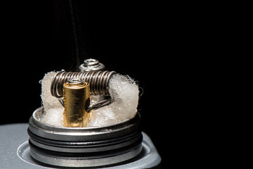mod with wet cotton driptip on a black background for vaping smoke