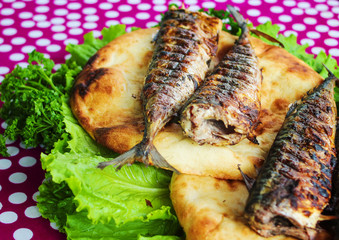 Serving fried fish with greens