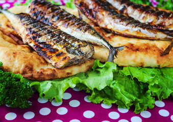 Serving fried fish with greens