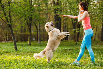 Sporty woman playing with dog