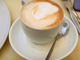 white cup of fresh cappuccino