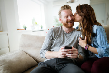 Obraz premium Romantic young couple expressing their love by kissing