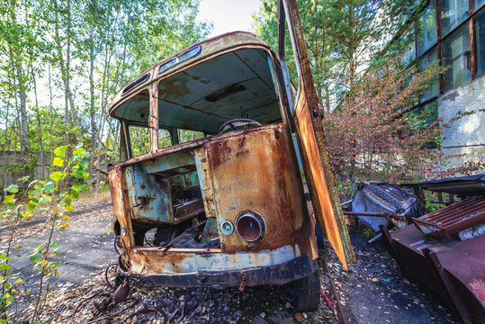 Bus wreck in desolate factory in Pripyat desolate city in Chernobyl Exclusion Zone, Ukraine