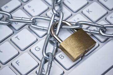 Security lock and chained on computer keyboard - computer data security concept