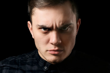 Obraz premium Handsome man on dark background, closeup