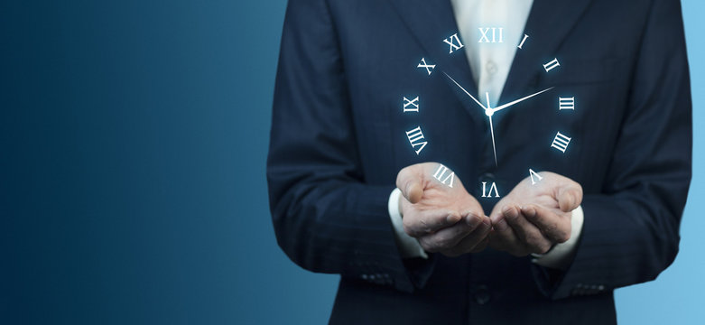 IreriBusinessman hand holding clock