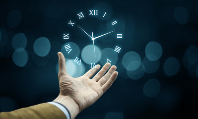 Businessman hand holding clock
