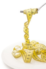 Diet concept, measuring tape looks like pasta put on fork, on white background, losing weight