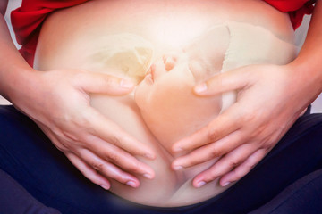 Fototapeta na wymiar Pregnant Woman with Newborn baby in her Belly