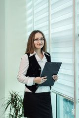 Modern business woman in the office with copy space,Business woman portrait,Successful business woman looking confident and smiling,business woman in glasses,