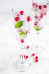 fresh cranberry in ice cubes in glasses on white background mock-up