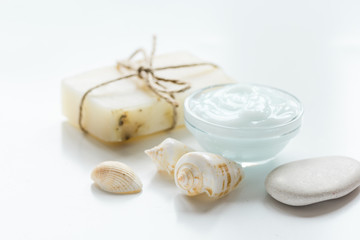 blue spa composition with shells and natural soap on white desk background