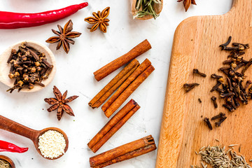 Cooking with spices, salt and pepper on kitchen table background top view