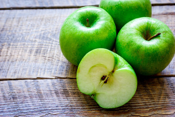 ripe green apples wooden table background