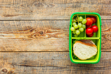 school lunch set with sandwich and vegetables in lunchbox background top view mock up