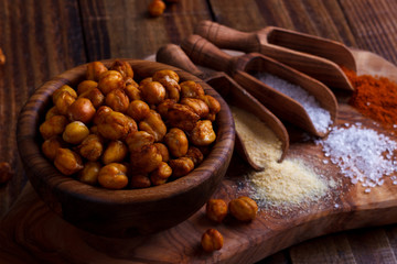 Roasted spicy chickpeas on rustic background